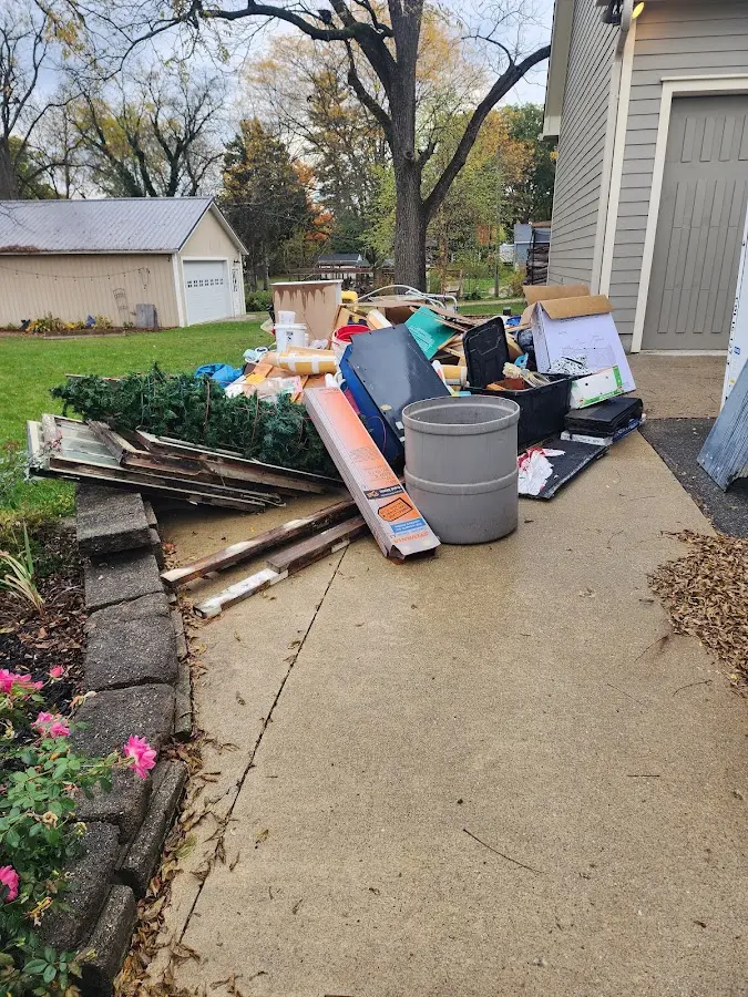 Dumpster being loaded with debris for Estate Cleanout Dumpster Rental in Dunstable